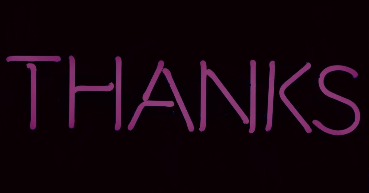 pink neon thanks sign on dark background