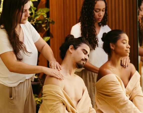 women massaging clients at spa