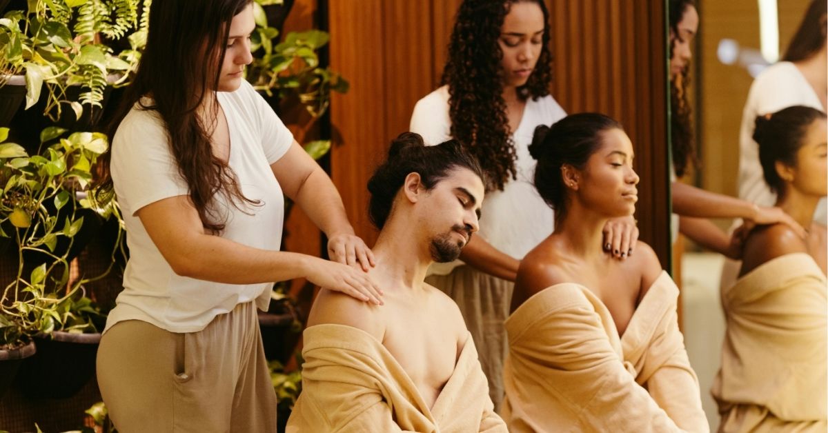 women massaging clients at spa